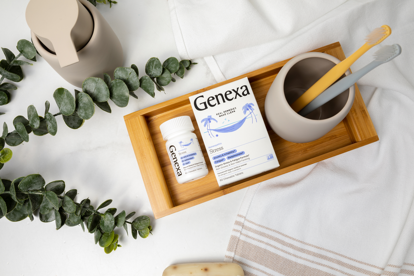 Genexa stress bottle on a wooden tray with a white bathroom background