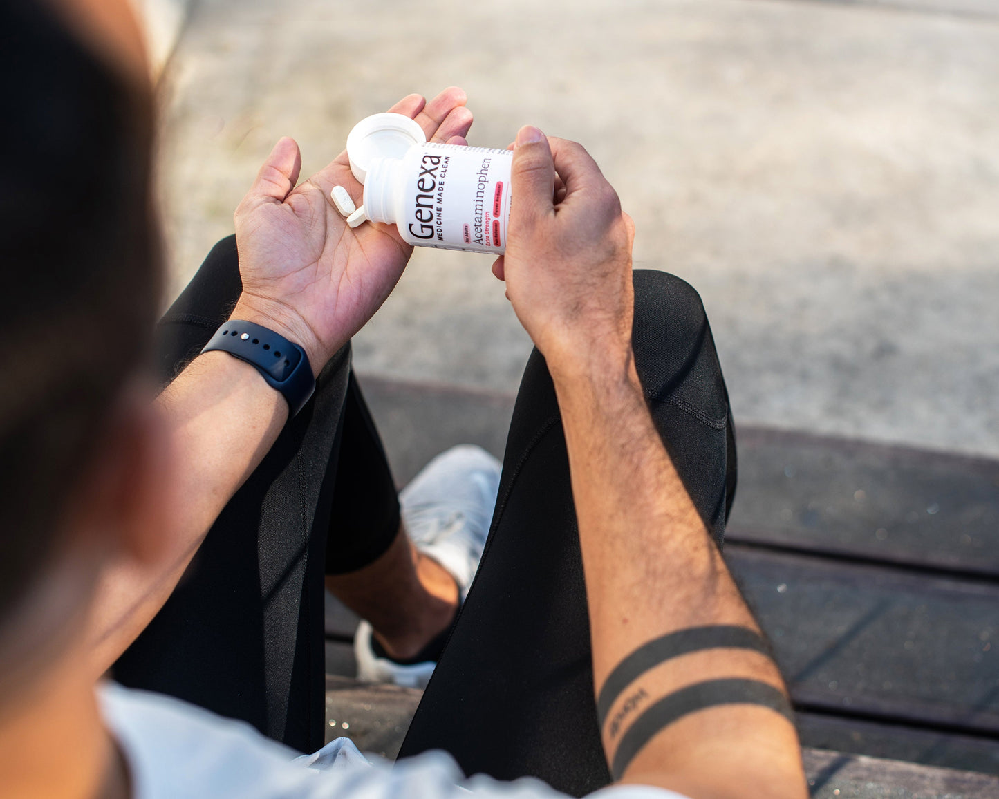 Man pouring Genexa Adult Acetaminophen into open hand