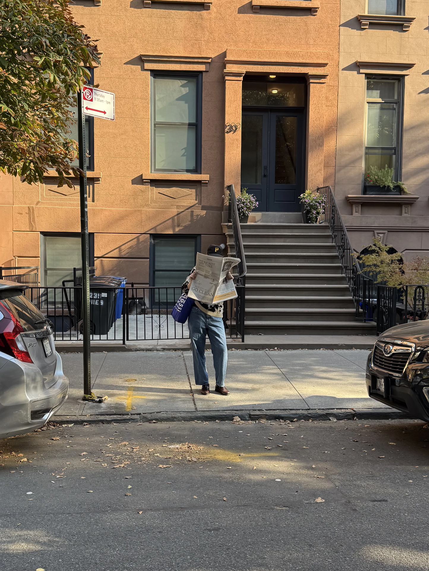 a person holding an ad for the new york times with Genexa on the back page