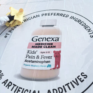 Genexa Kids' Pain & Fever Acetaminophen bottle on a circular product label background