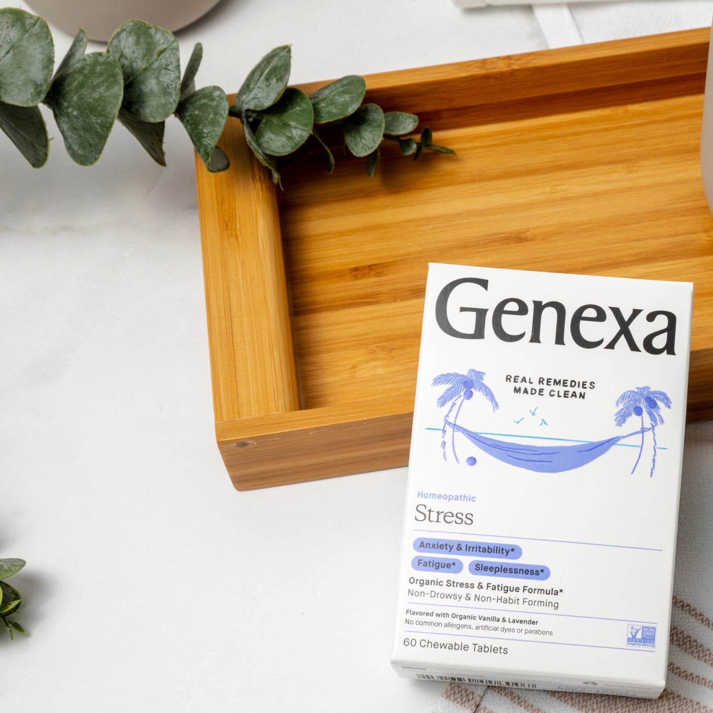 Genexa Stress supplement box on a wooden tray with greenery